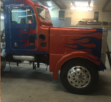 side view of custom paint job flames on big rig