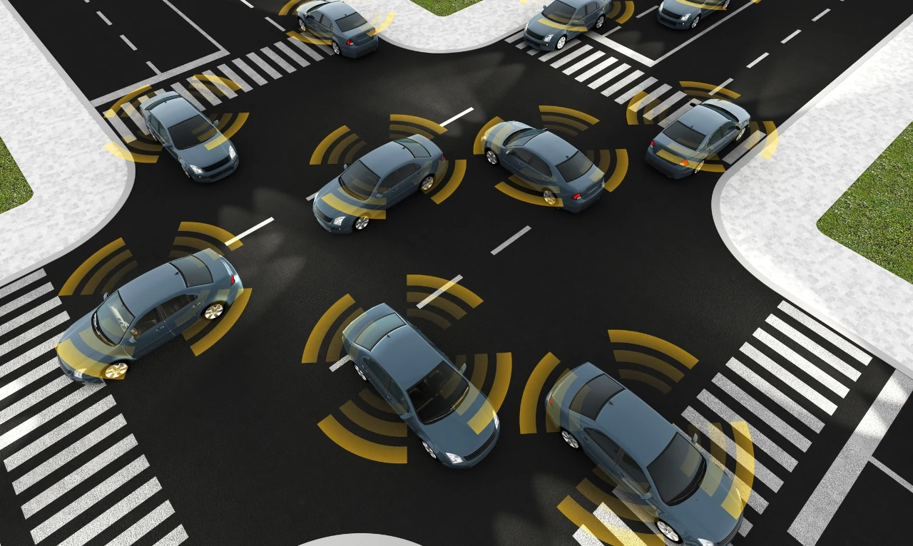 Illustration of vehicles in an intersection with crash detection sensors coming from vehicles